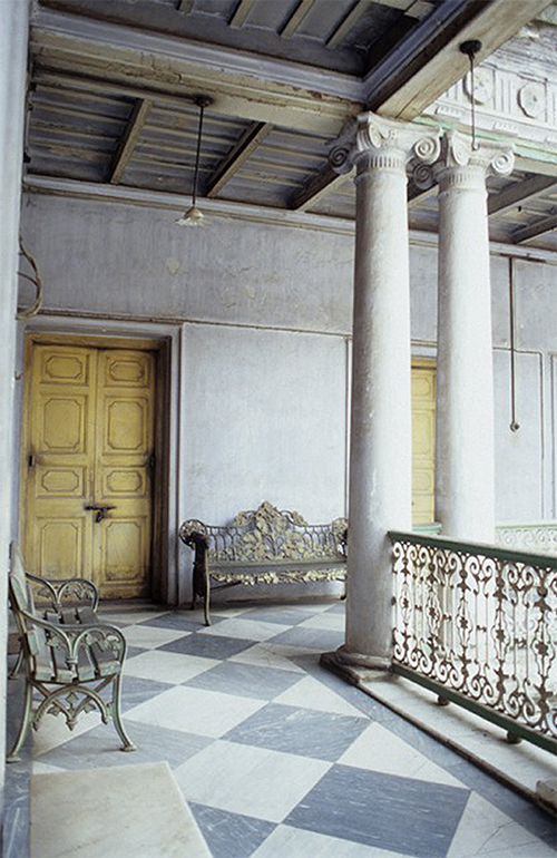 Inside Expensive Older Building with Columns, gold benches, and high ceilings