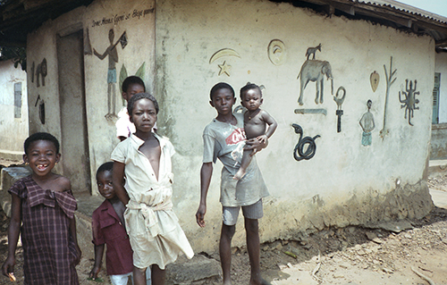 Young Ghanain Children in Front of Building with Mural