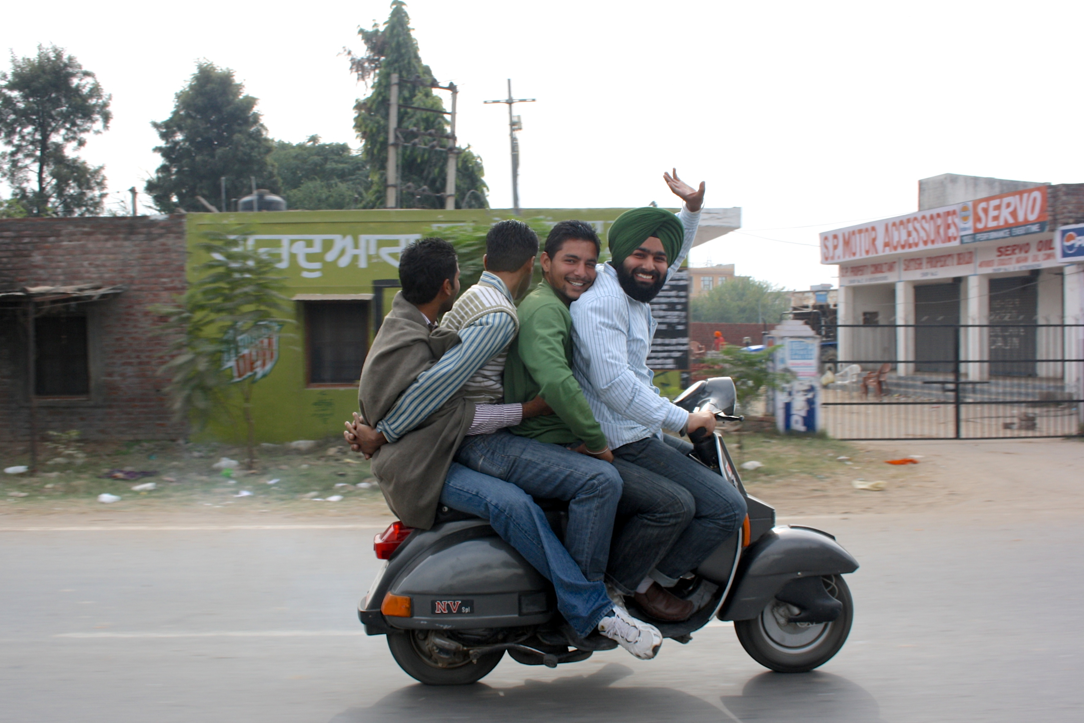 Four men riding a bike