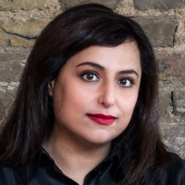 portrait of Hoor Al Qasimi in front of a brick wall