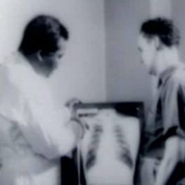 Doctor showing X-ray to a man