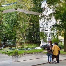 Group of three people looking at monument made of reflective material made by artist Karyn Olivier titled "The Battle is Joined, Vernon Park", for Monument Lab 2017 ( Photo by:Mike Reali/Mural Arts Philadelphia).  