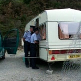 Two policemen looking into a bus