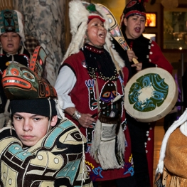 Indigenous dancers and musicians in regalia. 