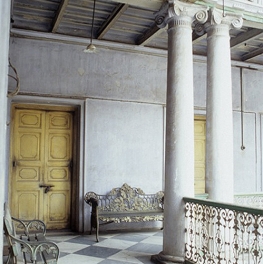 Inside Expensive Older Building with Columns, gold benches, and high ceilings