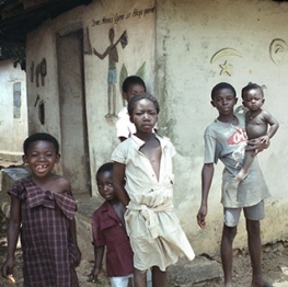 Young Ghanain Children in Front of Building with Mural
