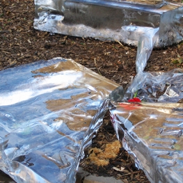 Block of ice melting on dirt